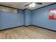 Bedroom featuring wood floors, a window, and blue walls with white trim at 2882 Clary Hill Ne Dr, Roswell, GA 30075