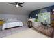 Spacious bedroom featuring a comfortable bed, seating area, and large window with shutters at 2882 Clary Hill Ne Dr, Roswell, GA 30075