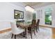 Elegant dining room features a modern chandelier, decorative mirror, and a stylish glass-top table at 2882 Clary Hill Ne Dr, Roswell, GA 30075