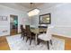 Elegant dining room featuring a modern chandelier, glass-top table, and stylish decor at 2882 Clary Hill Ne Dr, Roswell, GA 30075
