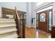 Grand foyer featuring hardwood floors, a staircase, and a front door with decorative glass at 2882 Clary Hill Ne Dr, Roswell, GA 30075
