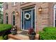 Charming front entrance with a wreath, potted plants, and decorative lighting at 2882 Clary Hill Ne Dr, Roswell, GA 30075