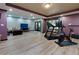 Home gym area featuring a treadmill, elliptical, and a ping pong table at 2882 Clary Hill Ne Dr, Roswell, GA 30075