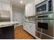 Well-equipped kitchen with stainless steel oven and microwave, granite counters, and stylish backsplash at 2882 Clary Hill Ne Dr, Roswell, GA 30075
