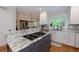 Charming kitchen with granite counters, stainless cooktop, and white cabinets for a clean, modern feel at 2882 Clary Hill Ne Dr, Roswell, GA 30075