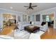 Spacious living room features hardwood floors, a ceiling fan, and comfortable seating arrangements at 2882 Clary Hill Ne Dr, Roswell, GA 30075