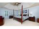 Spacious main bedroom with four-poster bed, tray ceiling, plantation shutters, and neutral color palette at 2882 Clary Hill Ne Dr, Roswell, GA 30075