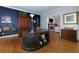 Well-appointed home office with a large desk, built-in storage, and a view into the living room at 2882 Clary Hill Ne Dr, Roswell, GA 30075