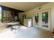 Covered patio area featuring a round table, chair, storage unit, and access to the home's interior via glass doors at 2882 Clary Hill Ne Dr, Roswell, GA 30075