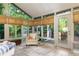 Relaxing sunroom offers outdoor views and access to a deck, enhancing the indoor-outdoor flow at 2882 Clary Hill Ne Dr, Roswell, GA 30075