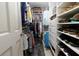 Organized walk-in closet with shelving, hanging rods, and drawers for ample storage space at 2882 Clary Hill Ne Dr, Roswell, GA 30075