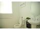 Half bathroom featuring modern fixtures, a stylish pedestal sink, and a decorative sign at 423 Ward Ln, Woodstock, GA 30188