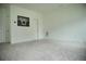 Bright bedroom offers neutral carpet and a large blank wall for decor at 423 Ward Ln, Woodstock, GA 30188