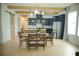 Open-concept dining room with views to the kitchen, natural light, stylish lights and an adjacent barn door at 423 Ward Ln, Woodstock, GA 30188