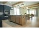 Open-concept kitchen with blue cabinets, center island with counter seating, and views to the dining area at 423 Ward Ln, Woodstock, GA 30188