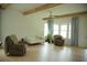 Spacious living room with high ceilings, lots of windows, a ceiling fan, hardwood floors and comfortable seating at 423 Ward Ln, Woodstock, GA 30188