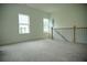This well-lit loft features a staircase, neutral carpet, and bright windows at 423 Ward Ln, Woodstock, GA 30188