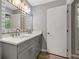 Gray bathroom featuring a double sink vanity and a large mirror at 4406 Idlewood Ln, Tucker, GA 30084