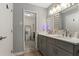 Bathroom with a double vanity, a mirror, modern lighting, and wood-look flooring at 4406 Idlewood Ln, Tucker, GA 30084