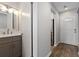 Bright bathroom featuring a modern vanity, decorative mirror, and stylish fixtures at 4406 Idlewood Ln, Tucker, GA 30084