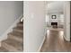 Entryway with carpeted stairs and wood-look flooring leading to the living room at 4406 Idlewood Ln, Tucker, GA 30084