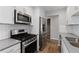 Contemporary kitchen with modern stainless appliances, white cabinets, subway tile backsplash, and neutral countertops at 4406 Idlewood Ln, Tucker, GA 30084