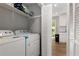Laundry room with washer, dryer, shelving, and wood-look flooring at 4406 Idlewood Ln, Tucker, GA 30084