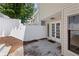Private patio with a white fence and double glass doors at 4406 Idlewood Ln, Tucker, GA 30084