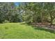 Large backyard with mature trees, a swing set, and plenty of room to run at 4825 Rollins Dr, Powder Springs, GA 30127