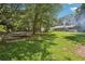 Large backyard with mature trees, green grass, and play structure for Gathering fun at 4825 Rollins Dr, Powder Springs, GA 30127