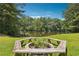Picturesque backyard featuring a tranquil lake view and an inviting fire pit area at 4825 Rollins Dr, Powder Springs, GA 30127