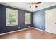 Cozy bedroom featuring hardwood floors, updated windows, and a ceiling fan at 4825 Rollins Dr, Powder Springs, GA 30127