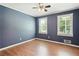 Bedroom with hardwood floors, neutral paint, and natural light from two windows at 4825 Rollins Dr, Powder Springs, GA 30127
