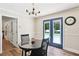 Bright dining area featuring wood floors, a modern chandelier, and a door leading to the backyard pool at 4825 Rollins Dr, Powder Springs, GA 30127