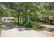 Ranch-style home with mature trees, spacious driveway, and inviting front porch at 4825 Rollins Dr, Powder Springs, GA 30127