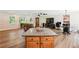 Large living space with wood floors and open concept with access to kitchen at 4825 Rollins Dr, Powder Springs, GA 30127