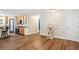 Open-concept living area with hardwood floors, adjacent to a kitchen with stainless steel appliances at 4825 Rollins Dr, Powder Springs, GA 30127