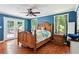 Cozy main bedroom with hardwood floors, blue walls, and French doors to a patio at 4825 Rollins Dr, Powder Springs, GA 30127