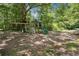 Backyard playground with swing set, climbing wall, slide, and playhouse at 4825 Rollins Dr, Powder Springs, GA 30127