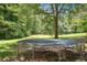 Large trampoline in a grassy backyard setting with surrounding trees at 4825 Rollins Dr, Powder Springs, GA 30127