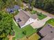 Aerial view of a charming home with lush green landscaping and a long driveway in a wooded area at 3445 Henderson Dr, Cumming, GA 30041