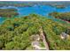 Beautiful aerial shot of a waterfront home surrounded by lush forests, serene water, and stunning natural beauty at 3445 Henderson Dr, Cumming, GA 30041