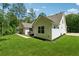 Expansive backyard features lush lawn and a charming white home with a spa on the rear patio at 3445 Henderson Dr, Cumming, GA 30041