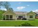 Beautiful backyard features a well-maintained lawn, covered porch, and a relaxing spa at 3445 Henderson Dr, Cumming, GA 30041