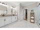 Elegant bathroom featuring double vanity, marble floors, and walk in closet at 3445 Henderson Dr, Cumming, GA 30041