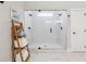 Modern bathroom with a glass-enclosed shower and decorative towel storage at 3445 Henderson Dr, Cumming, GA 30041
