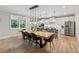 Bright dining area with pendant lighting open to a modern kitchen at 3445 Henderson Dr, Cumming, GA 30041