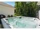 Close-up of a luxurious hot tub on the patio, perfect for relaxation with views of the wooded backyard at 3445 Henderson Dr, Cumming, GA 30041