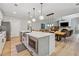 Open concept kitchen features stainless appliances, large island, and seamless access to dining and living areas at 3445 Henderson Dr, Cumming, GA 30041