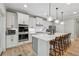 Modern kitchen with stainless steel appliances, a breakfast bar, and custom cabinetry at 3445 Henderson Dr, Cumming, GA 30041